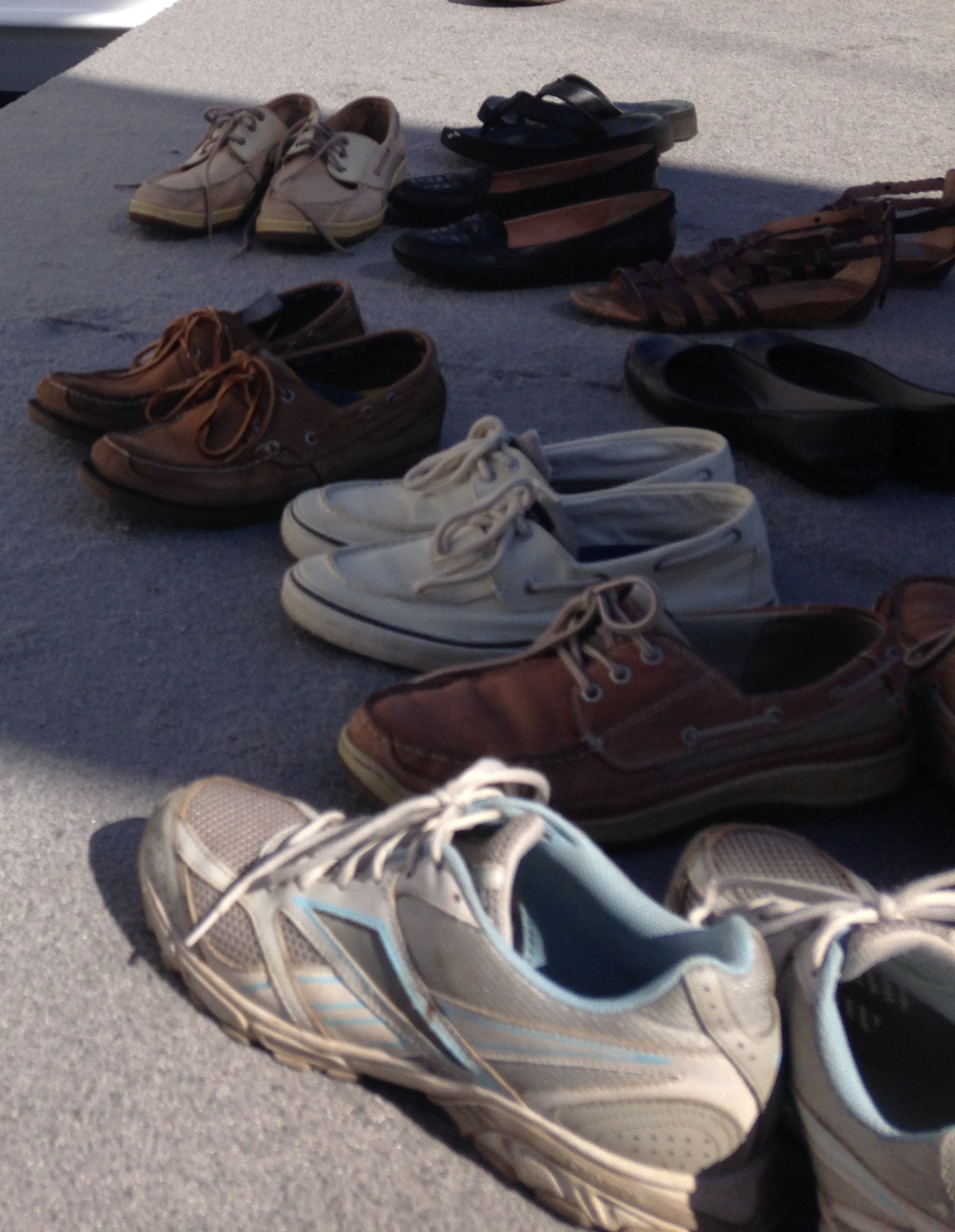 Photo of Shoes at the Annapolis Boat Shoes. All of the shoes are slip-ons except those of the first-time attendee, and writer.