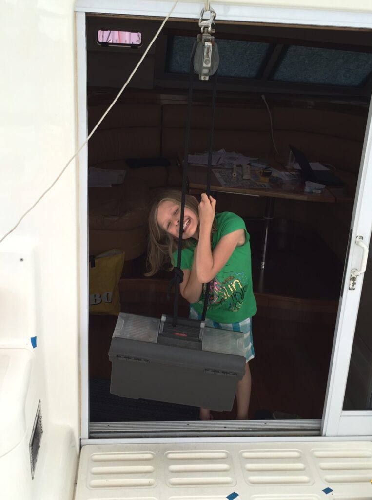 Homeschooling science on a sailboat: Betty learning about pulleys on the SV Aphrodite