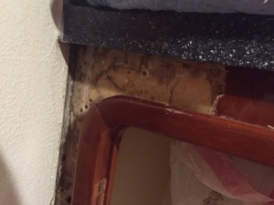 Cabinet facing as it is being primed for new cherry wood.