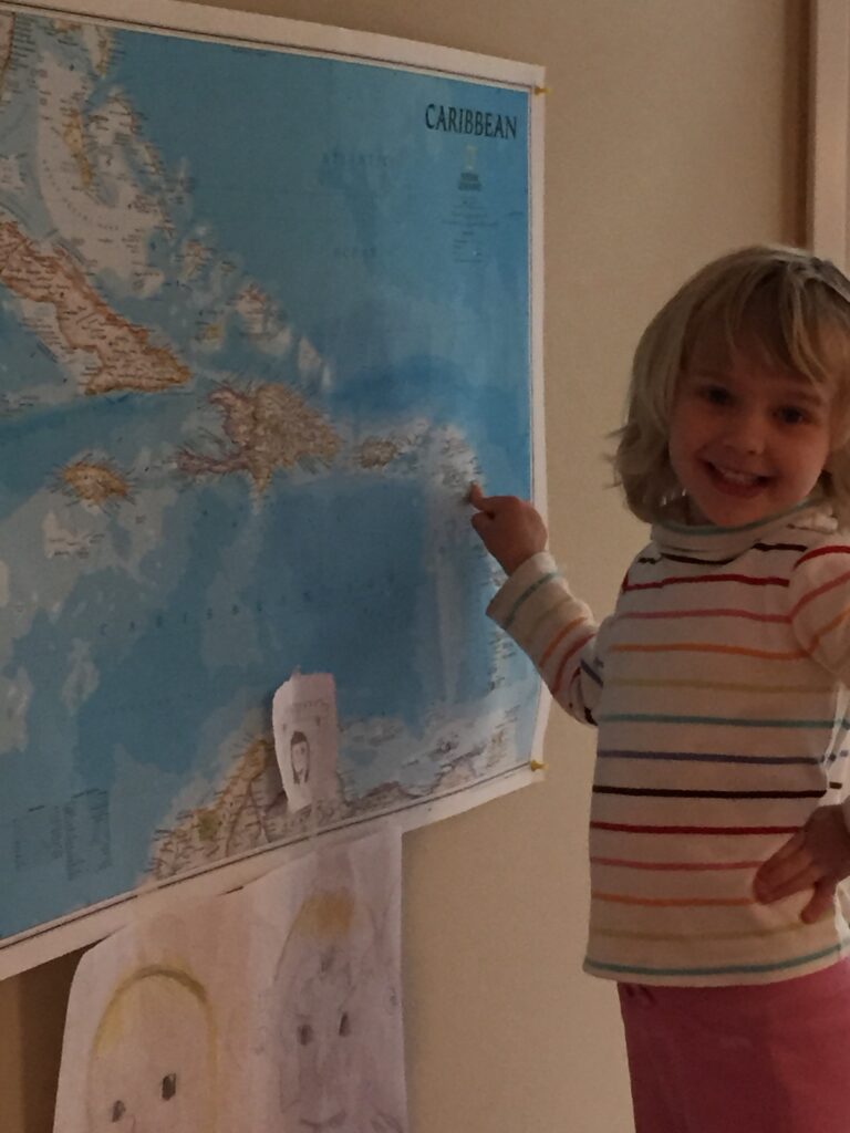 Karen of SV Aphrodite with a world map