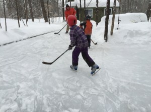 Shooting the puck with our kids on the outdoor rink that he built for them.