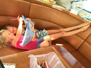 Karen (4) and Betty (9) enjoy a book on SV Aphrodite.