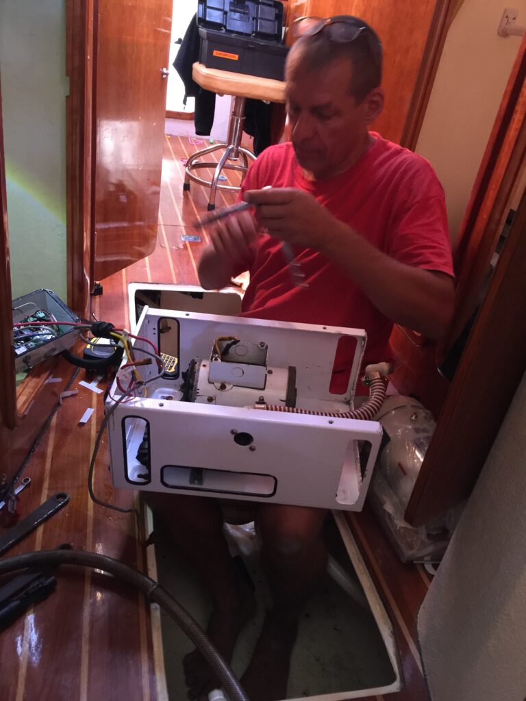 What goes wrong on a sailboat? The new motor looks like a canister on Rick's lap. The new motor is much larger. The new motor appears to the right of the photo.