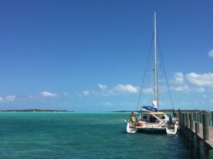 a sailboat attempts to leave the dock in strong winds.