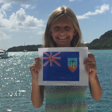 Writer of the Grade 6 Essay Sample, Betty with her hand-drawn Montserrat flag. Later, she laminated the flag and we flew it on our boat,, SV Aphrodite.