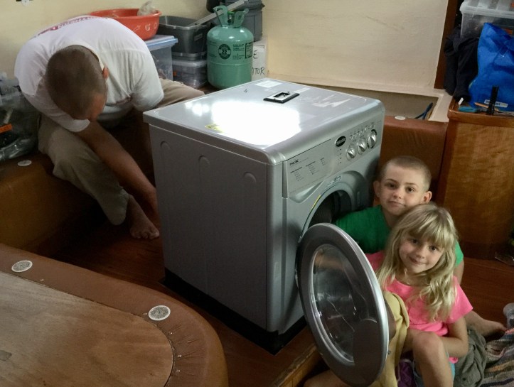 Kids on a St Francis 50 catamaran with a Splendide washing machine in the saloon.