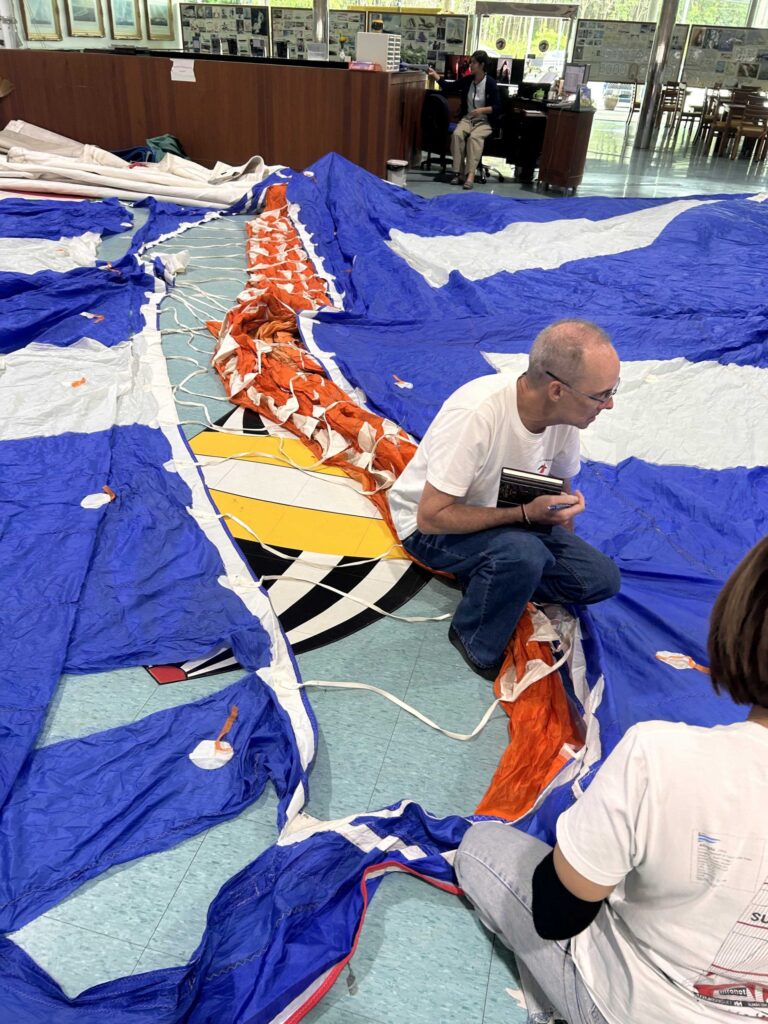 Torn Parasailor Sail being inspected at Rolly Tasket Phuket