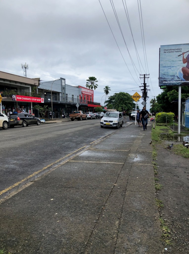Main Street, Savusavu, Fiji showing Ram Charan's 1 Stop Shop among others.