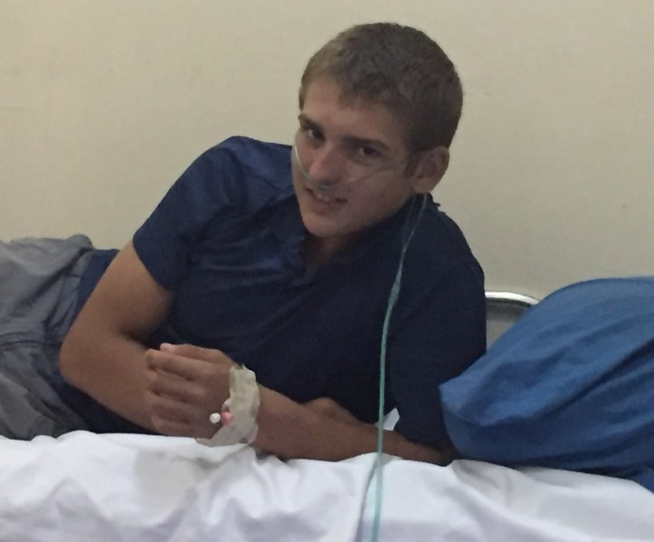 Paul in a hospital bed in Kavieng, Papua New Guinea, receiving oxygen therapy