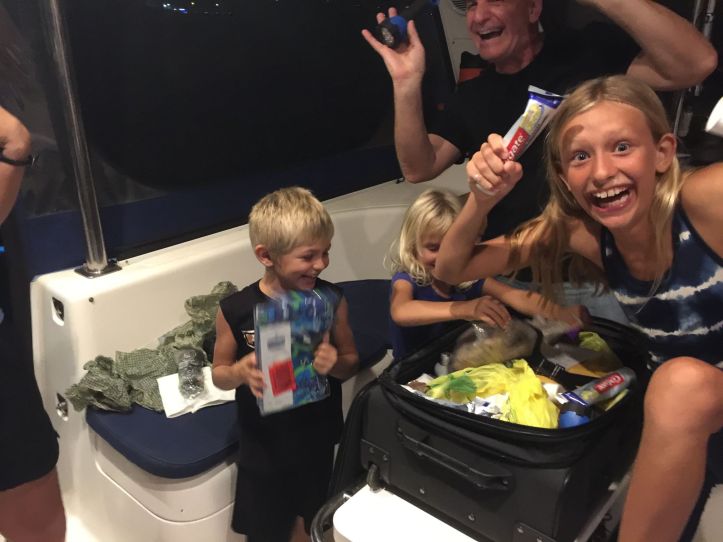 Kids excitedly opening a suitcase