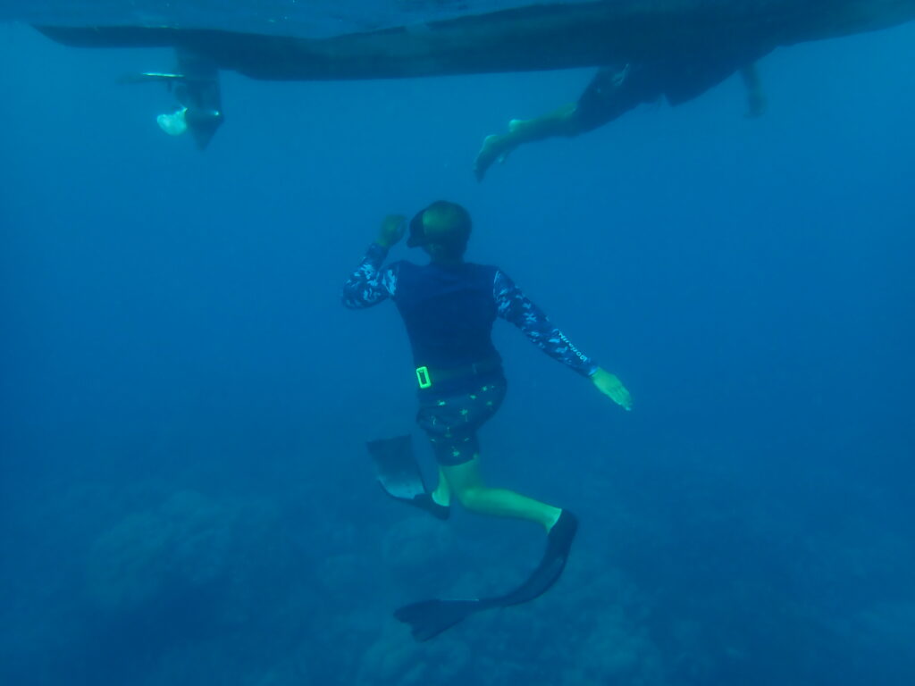 Underwater photo of dinghy with Paul and Rick