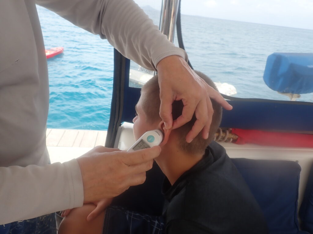 Henry getting his temperature taken in his ear