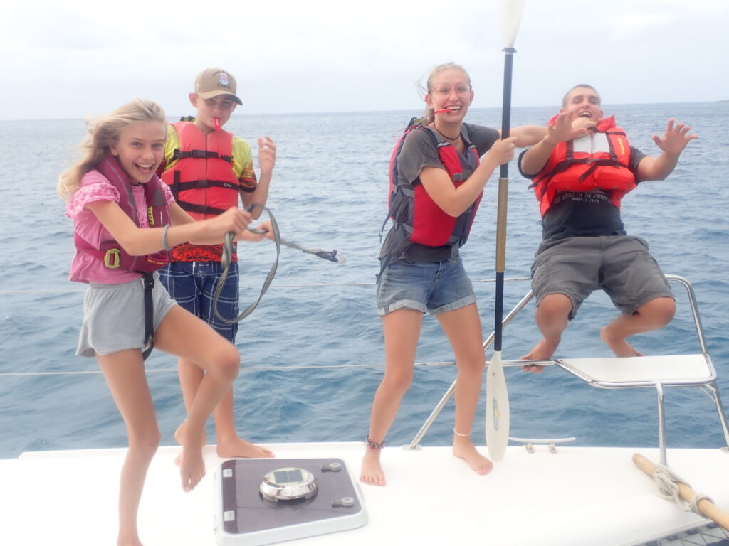 Child safety on a sailboat: My children modeling 4 different types of life jackets on SV Aphrodite