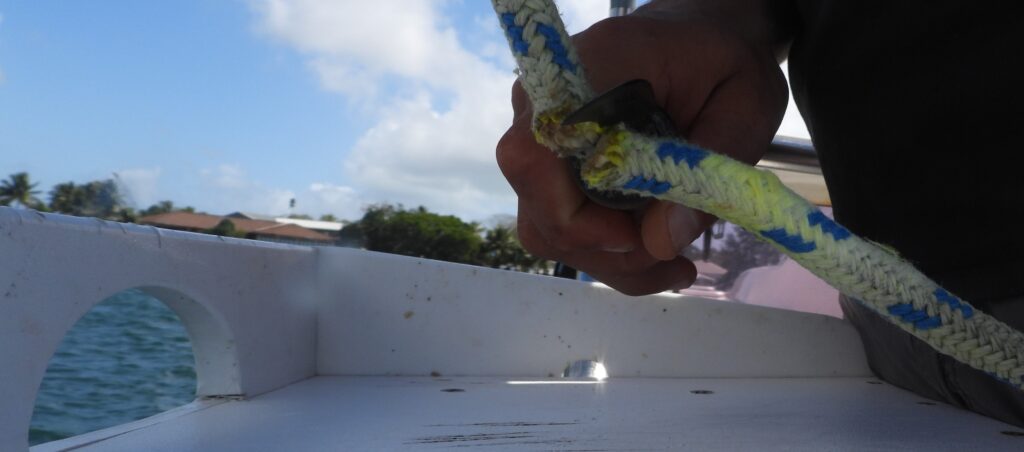 A carpet knife cutting through rope.