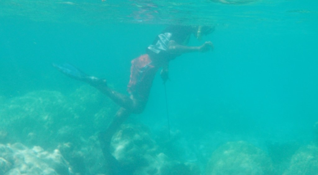 A boy spearfishes in Micronesia.