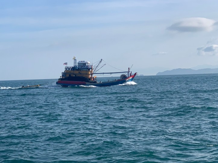 A colorful fishing boat in Thailand, one of many lovely sights to see while sailing.