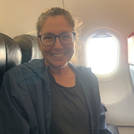 Lorraine Escher on a flight to Kuala Lumpur for trigger release surgery