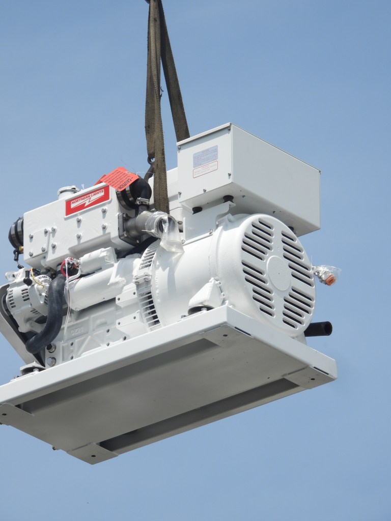 Close-up of our Northern Lights 9kW generator being lowered onto our catamaran, SV Aphrodite.