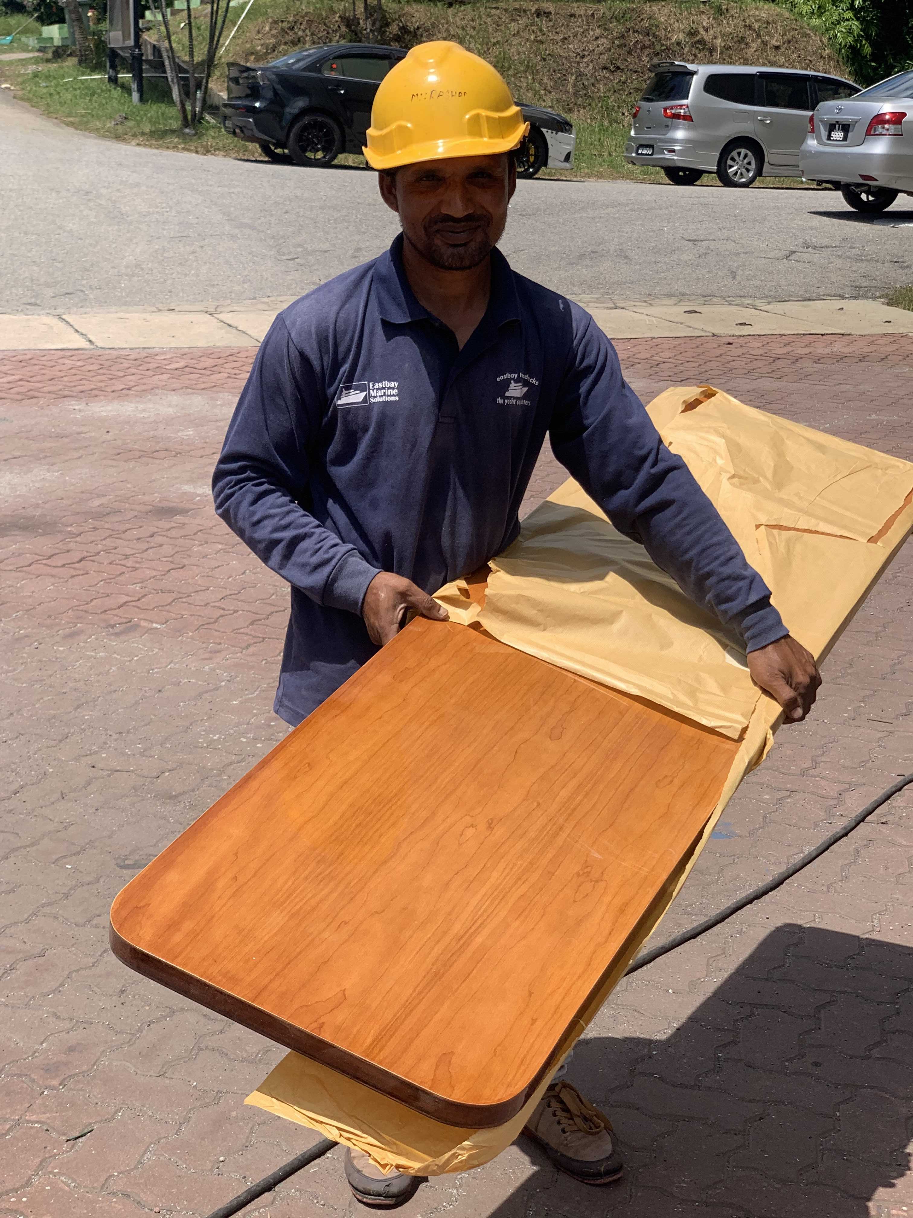 Rashid, site manager, in Langkawi of Eastbay shows us a completed, varnished door at Lunas Shipyard, formerly Boustead.