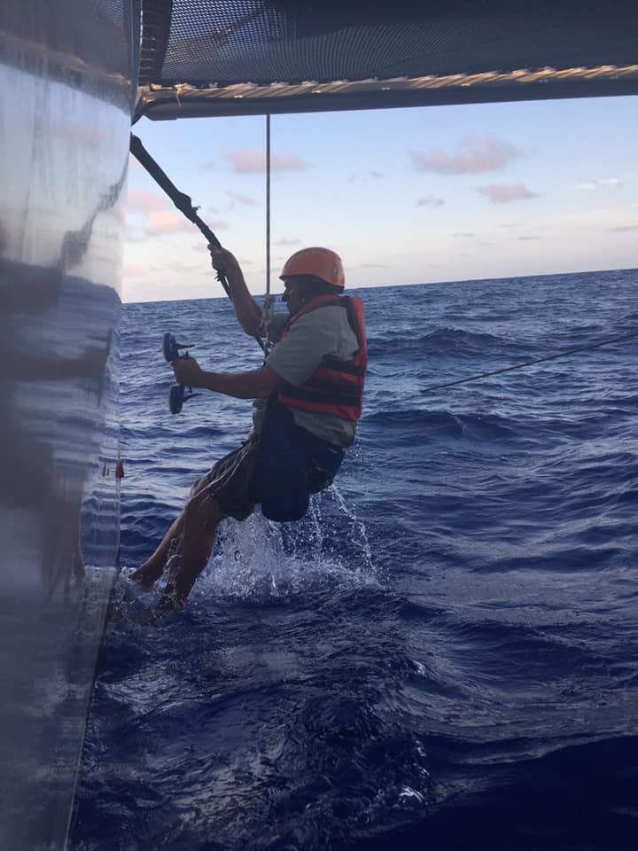 Rick holds a suction cup contraption to help in stay with the boat.