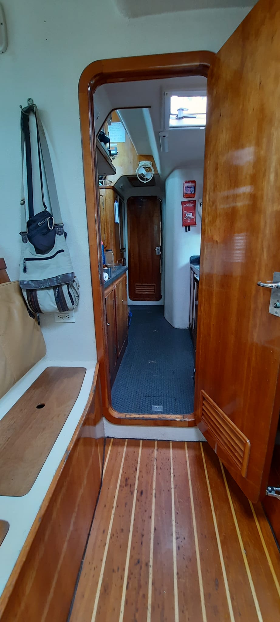View into the SV Aphrodite Galley before the woodwork began. You can see the original flooring is pockmarked. with damage.