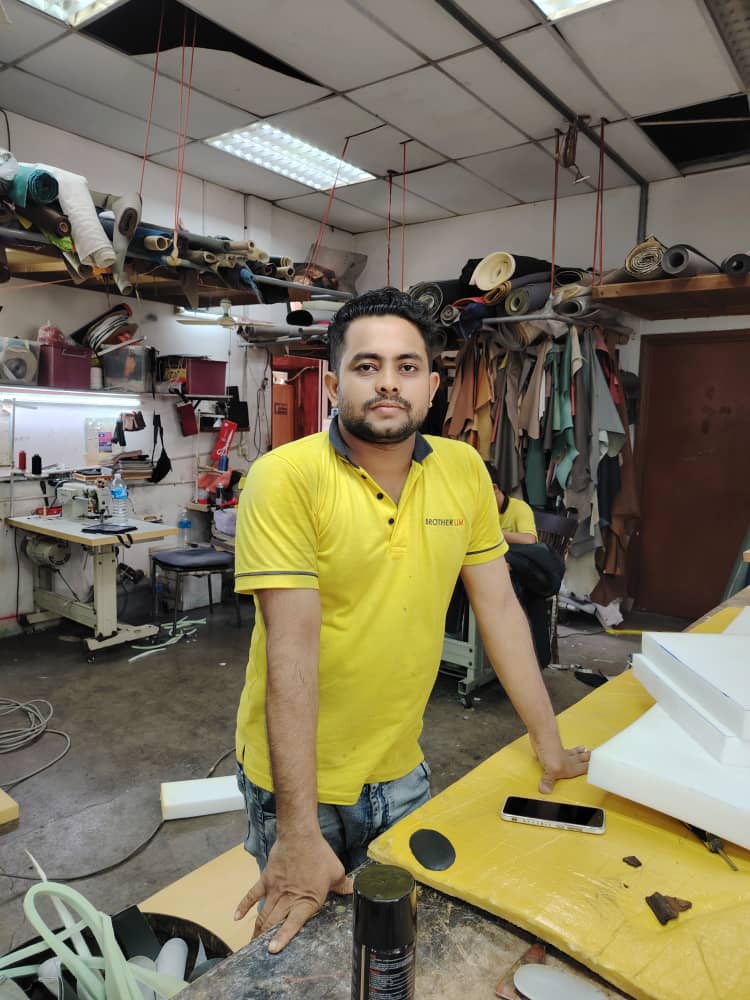 A man in a yellow shirt at Brother Lim Cushion in Kuala Lumpur, Malaysia.