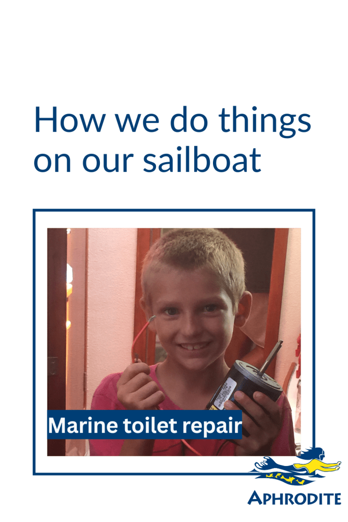 A young boy holds a toilet motor as he has learned a new skill which is how to fix marine toilets.