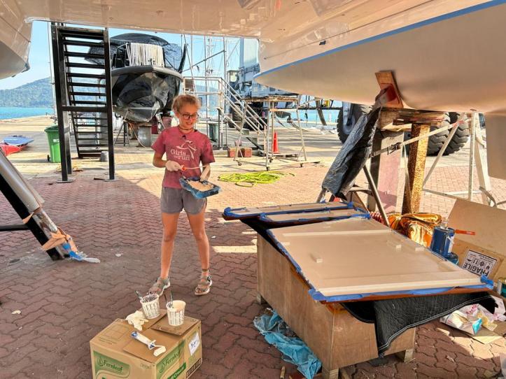 The scene below our boat, SV Aphrodite, as Karen paints the underside of our saloon table.