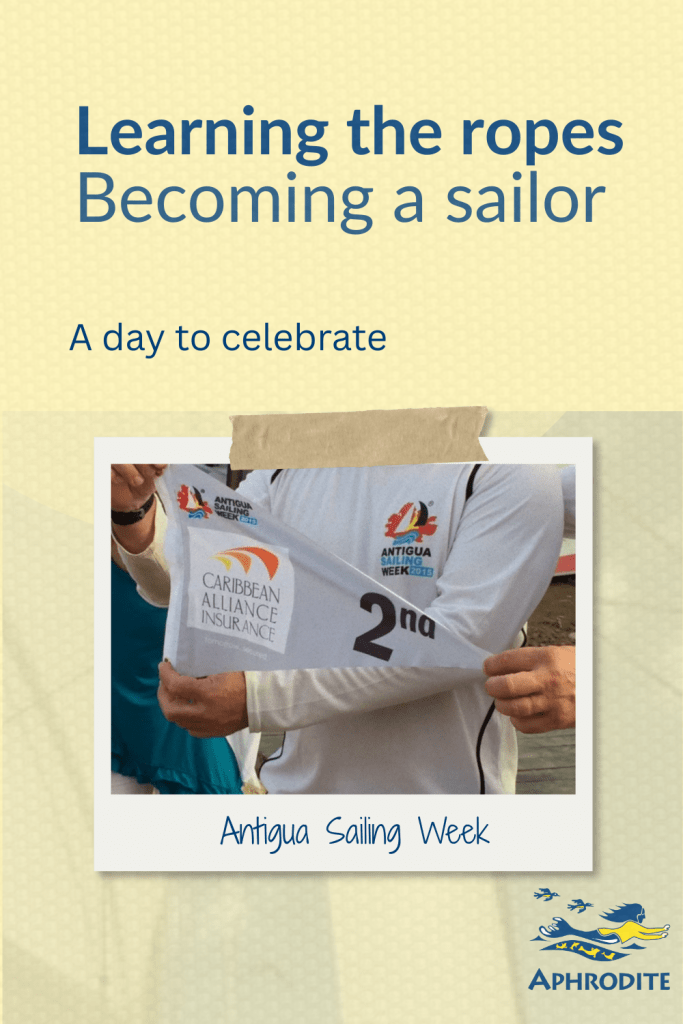 A sailor holds a 2nd place pennant during Antigua Sailing Week.
