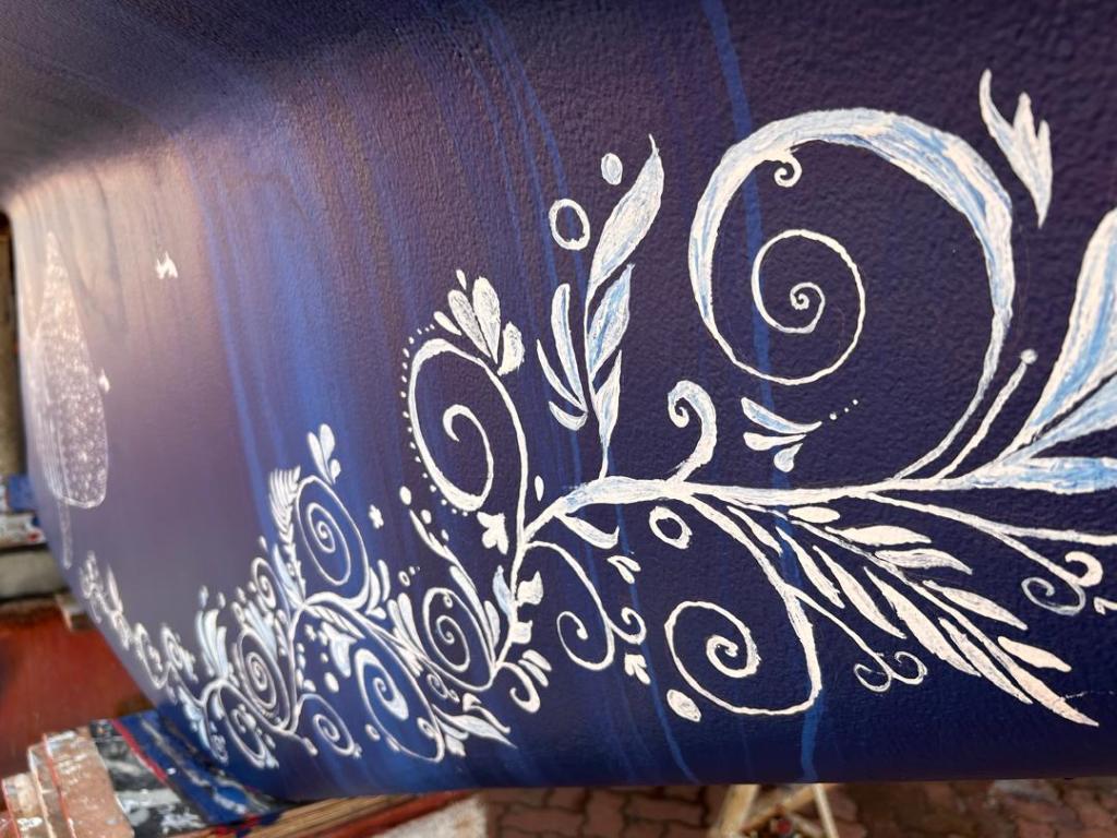close-up photo of the scrollwork that Karen painted on the keel of our St. Francis 50 catamaran, SV Aphrodite