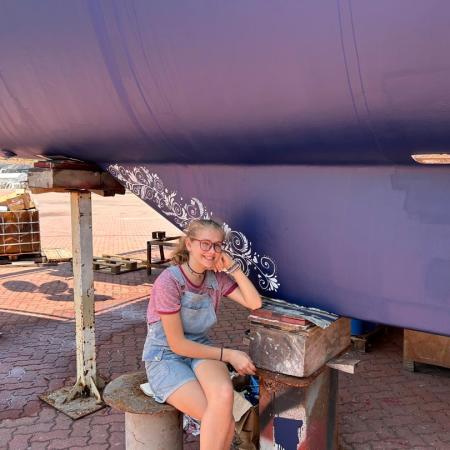 Karen Escher painting the keel in Langkawi, Malaysia.