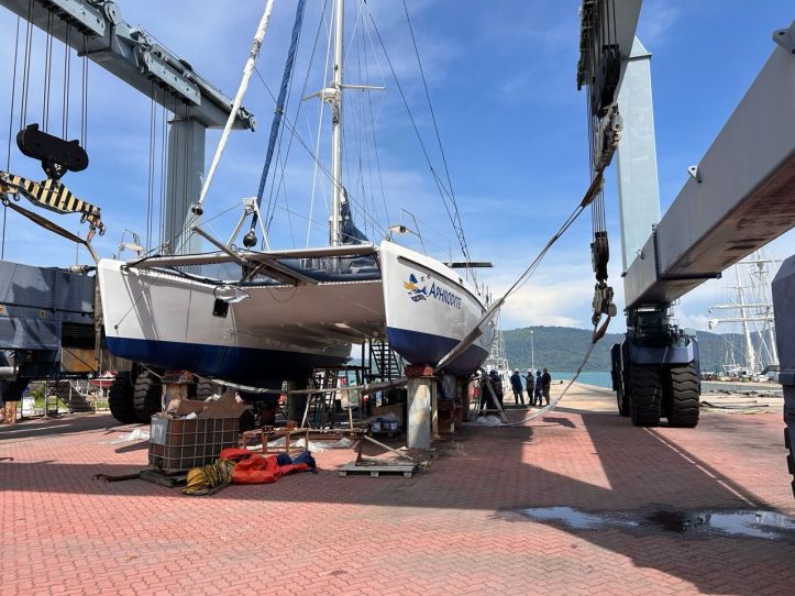 Boatyard workers standby during the launch of SV Aphrodite, a St. Francis 50 catamaran.
