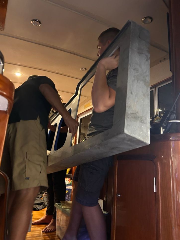 Rick and Henry carry our Corian countertop for installation on our St. Francis 50 catamaran, galley-down design.