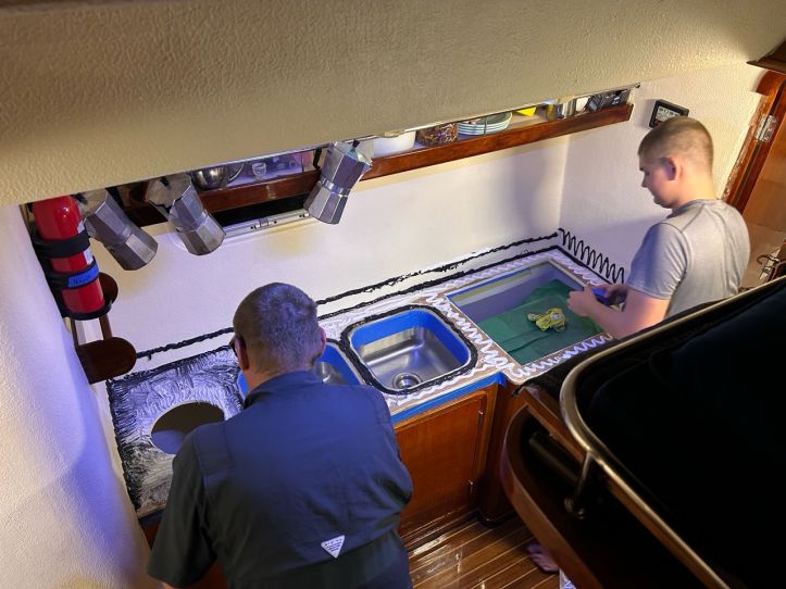 Rick and Henry prepare our Corian countertop on SV Aphrodite in our galley down design St. Francis 50 catamaran.