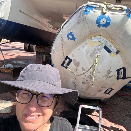 Blue tape on a hyalon Zar dinghy to prepare for a leak repair in Lunas Shipyard, Langkawi, Malaysia