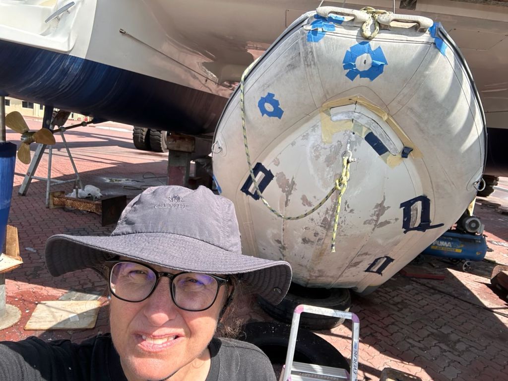 Blue tape on a hyalon Zar dinghy to prepare for a leak repair in Lunas Shipyard, Langkawi, Malaysia