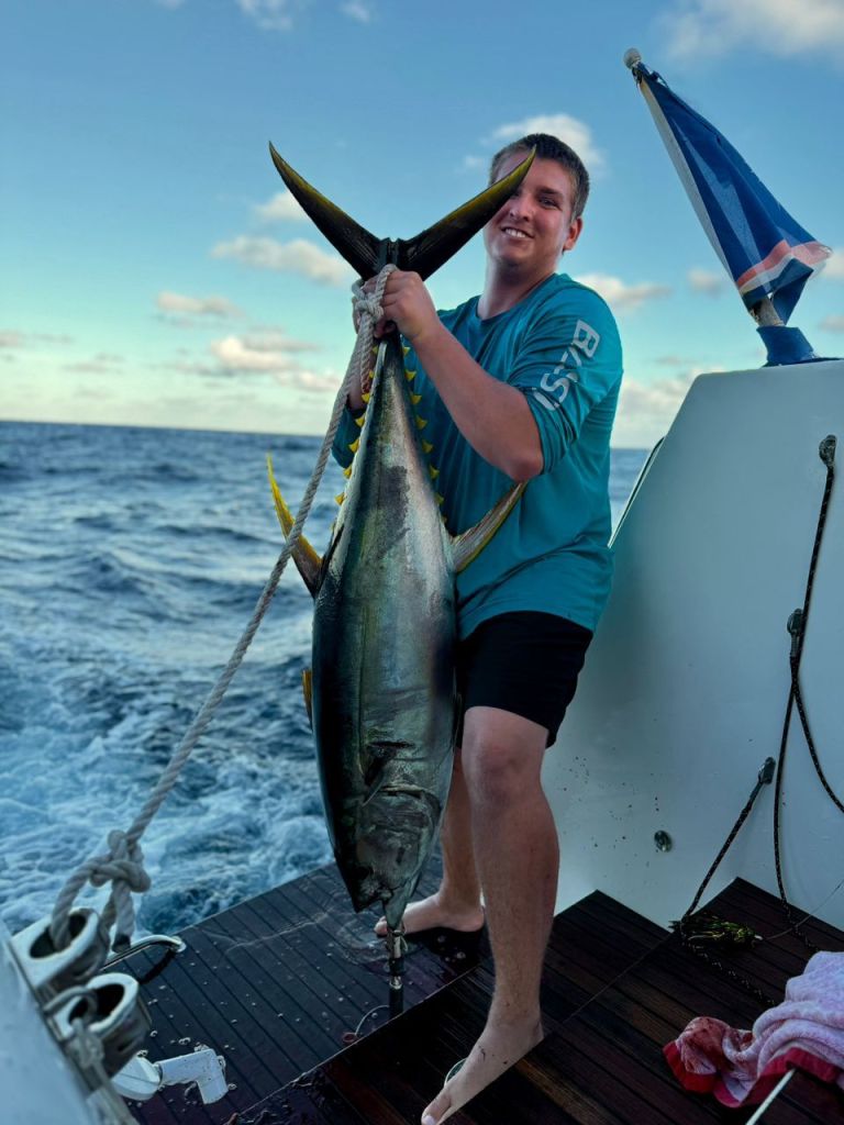 Paul with an 80-lb tuna that they caught during the Pacific Crossing while crewing on SV O'Vive