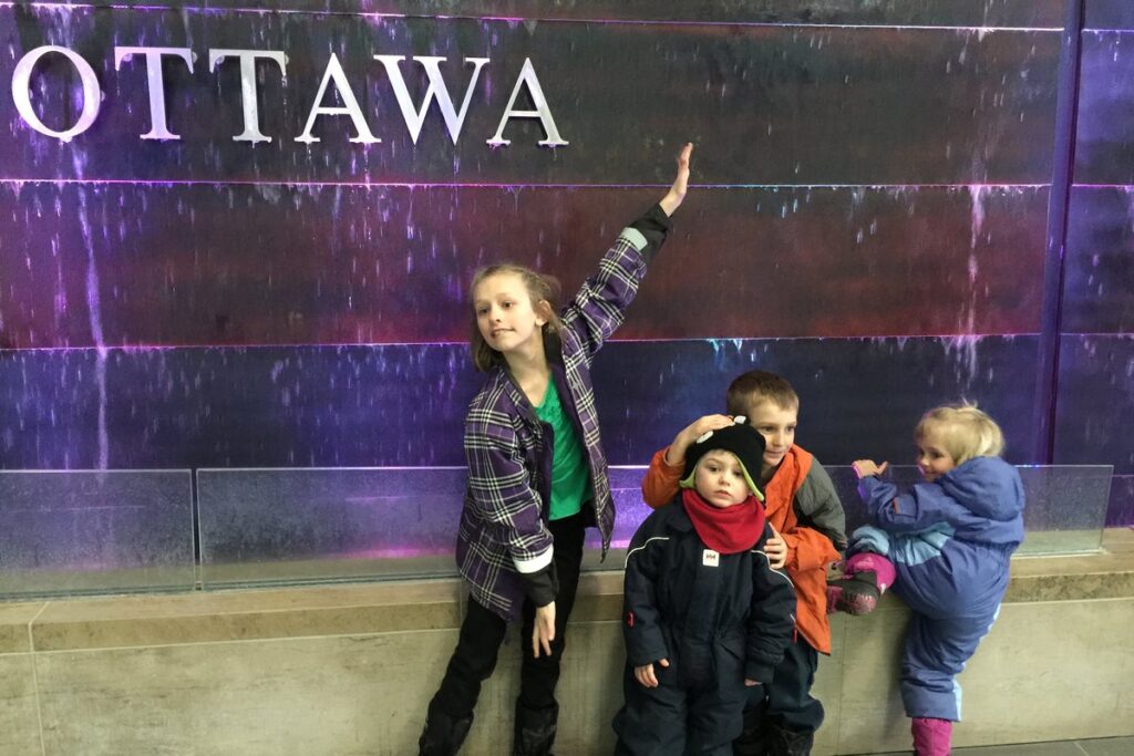 The Escher kids in front of the Ottawa sign, February 2015, before the family moved aboard